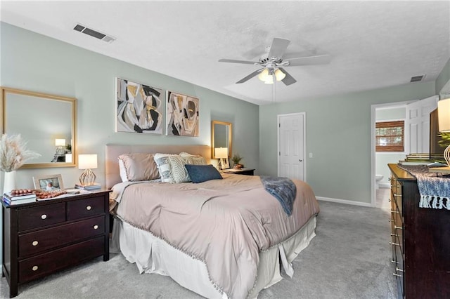 bedroom with ceiling fan, light carpet, visible vents, and baseboards