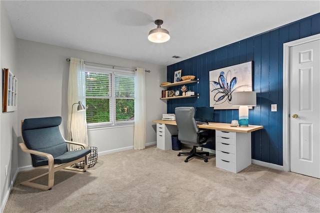 home office with baseboards and light colored carpet