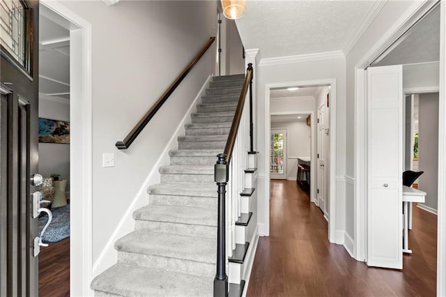 foyer entrance with stairs and dark wood-style flooring