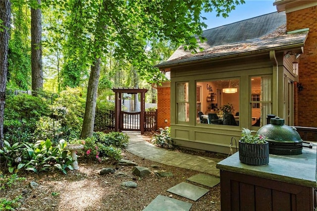 exterior space with brick siding and a shingled roof