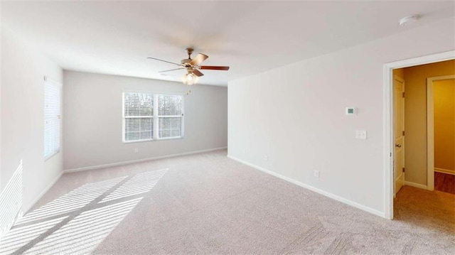 unfurnished room with light carpet, ceiling fan, and a wealth of natural light