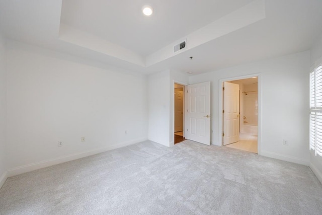 50 Biscayne Dr Unit 2106, Atlanta, GA 30309 - unfurnished bedroom featuring a tray ceiling, carpet floors, baseboards, and multiple windows