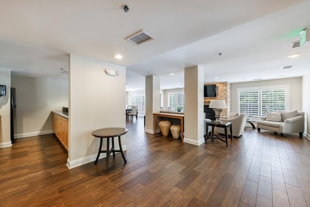 50 Biscayne Dr Unit 2106, Atlanta, GA 30309 - kitchen featuring dark wood-style flooring, open floor plan, a fireplace, baseboards, and recessed lighting