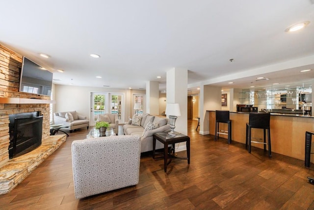 50 Biscayne Dr Unit 2106, Atlanta, GA 30309 - living area featuring a stone fireplace, dark wood finished floors, and recessed lighting