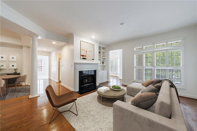 50 Biscayne Dr Unit 2106, Atlanta, GA 30309 - living room with ornate columns, wood finished floors, baseboards, ornamental molding, and a fireplace with flush hearth