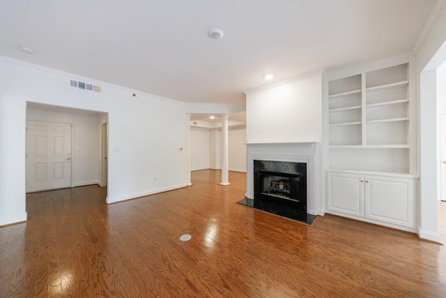 50 Biscayne Dr Unit 2106, Atlanta, GA 30309 - unfurnished living room with baseboards, ornamental molding, wood finished floors, a premium fireplace, and built in features