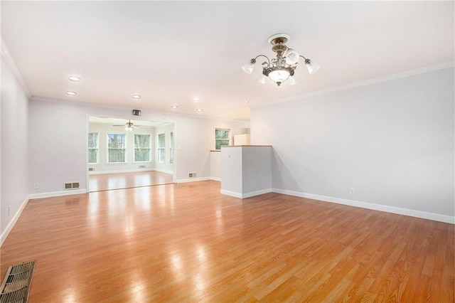 unfurnished living room with crown molding, ceiling fan with notable chandelier, and light hardwood / wood-style floors