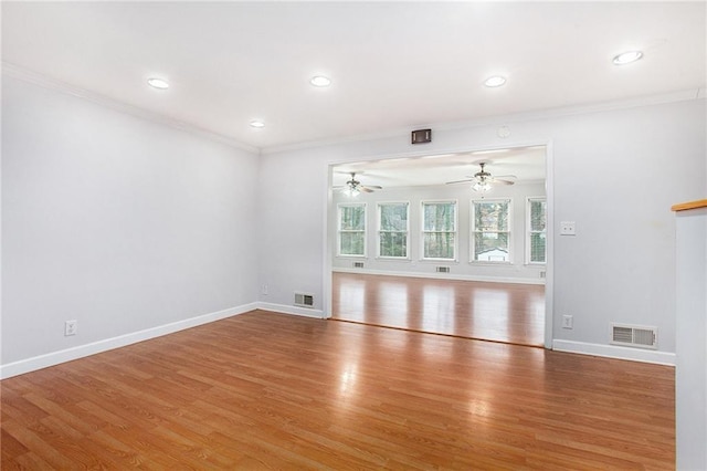 empty room featuring ceiling fan, ornamental molding, and wood-type flooring