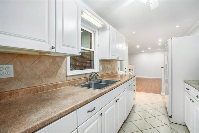 kitchen featuring white cabinetry, white appliances, sink, and decorative backsplash