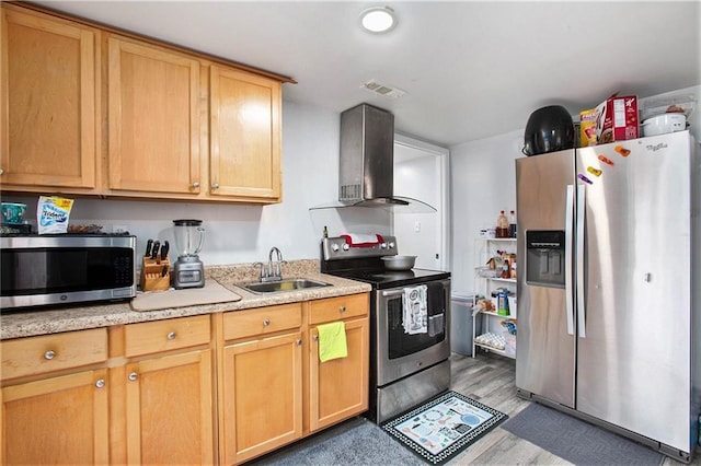 kitchen featuring sink, hardwood / wood-style floors, range hood, stainless steel appliances, and light brown cabinets