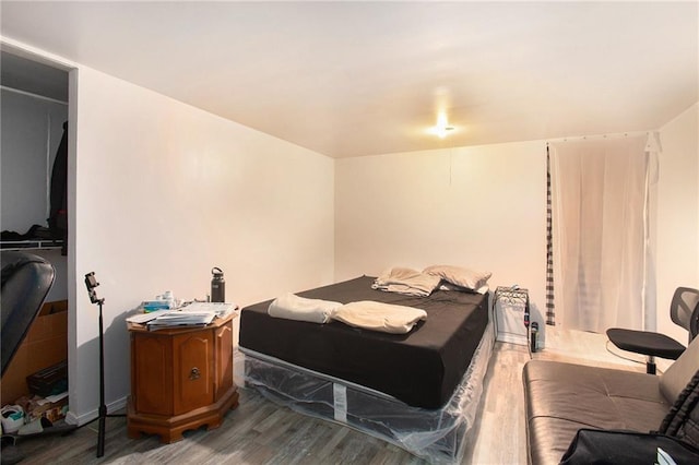 bedroom with wood-type flooring