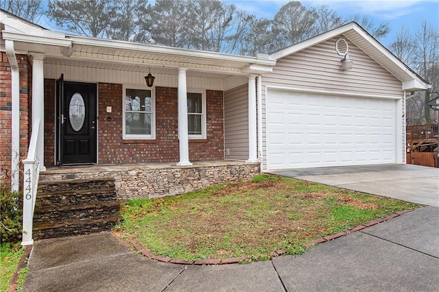 doorway to property featuring a porch and a garage