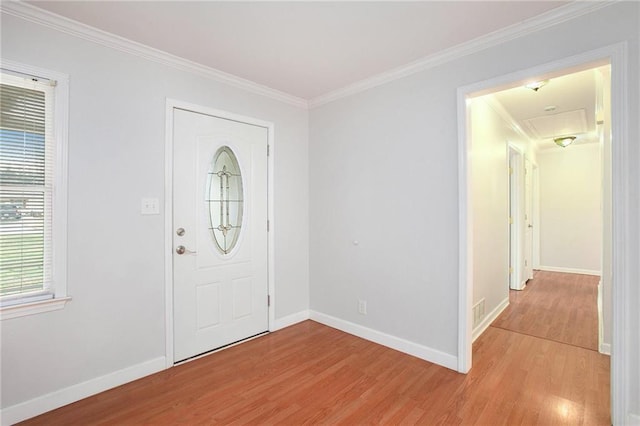 foyer entrance featuring ornamental molding and light wood-type flooring