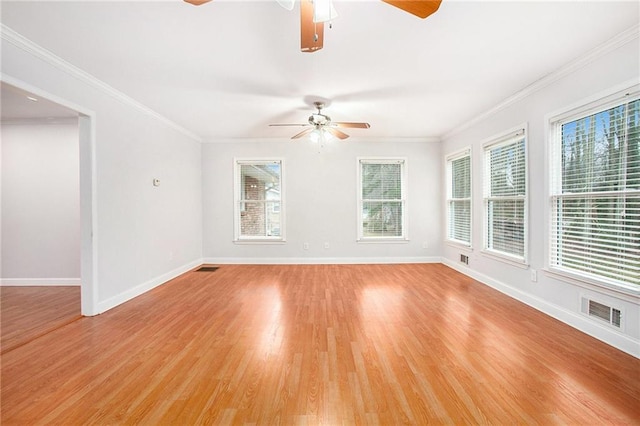 spare room featuring ornamental molding, ceiling fan, and light wood-type flooring