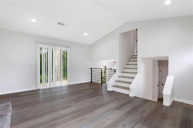 unfurnished room featuring lofted ceiling and dark hardwood / wood-style floors