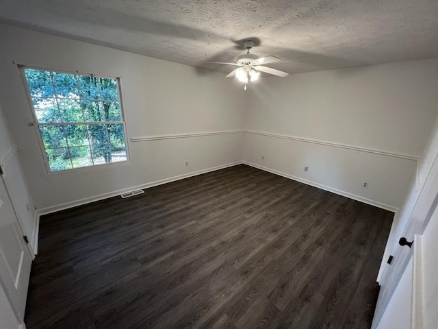 981 Dundee Dr, Lilburn, GA 30047 - unfurnished bedroom featuring visible vents, dark wood-type flooring, baseboards, a textured ceiling, and ceiling fan