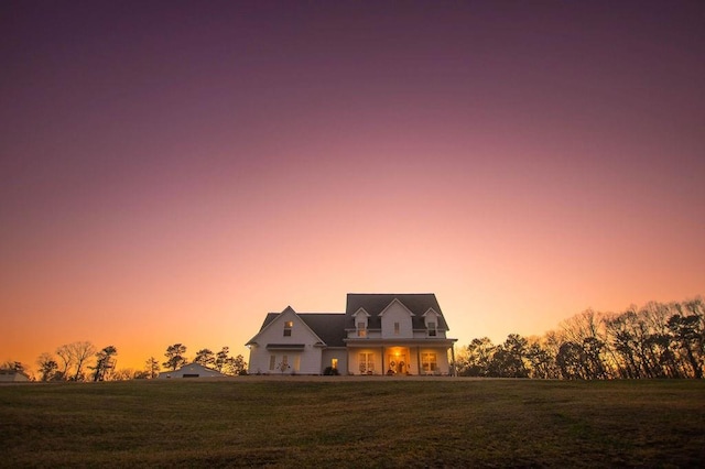 new england style home featuring a front lawn