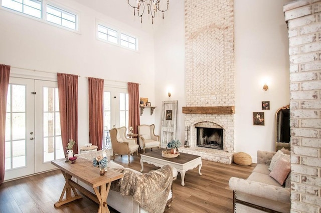 living room featuring plenty of natural light, wood finished floors, and french doors