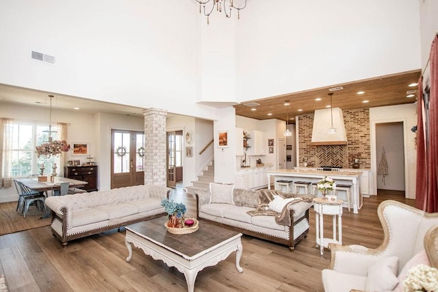 living room with recessed lighting, visible vents, a chandelier, and light wood-style flooring