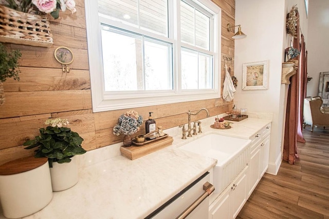 bathroom featuring wood finished floors, vanity, and wood walls