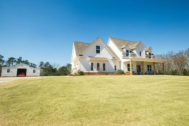 view of front facade featuring an outbuilding and a front lawn