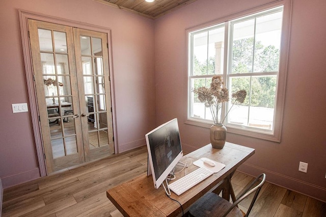 dining area featuring light wood-style flooring, french doors, and a wealth of natural light