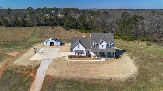 birds eye view of property with a rural view and a view of trees