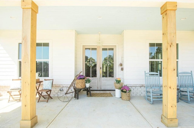 view of patio featuring a porch and french doors