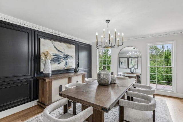 6124 Kings Mountain Ct, Stone Mountain, GA 30087 - dining area featuring light wood finished floors, ornamental molding, and a chandelier