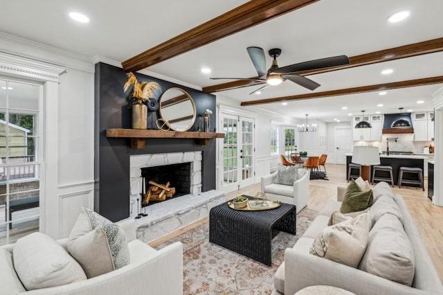 6124 Kings Mountain Ct, Stone Mountain, GA 30087 - living area featuring beamed ceiling, crown molding, a decorative wall, and a ceiling fan