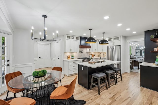 6124 Kings Mountain Ct, Stone Mountain, GA 30087 - kitchen featuring custom range hood, light countertops, a chandelier, and range
