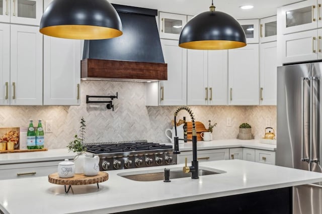 6124 Kings Mountain Ct, Stone Mountain, GA 30087 - kitchen featuring stainless steel refrigerator, light countertops, premium range hood, backsplash, and pendant lighting