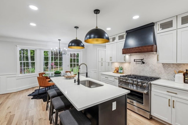 6124 Kings Mountain Ct, Stone Mountain, GA 30087 - kitchen featuring custom range hood, high end range, light countertops, and a sink