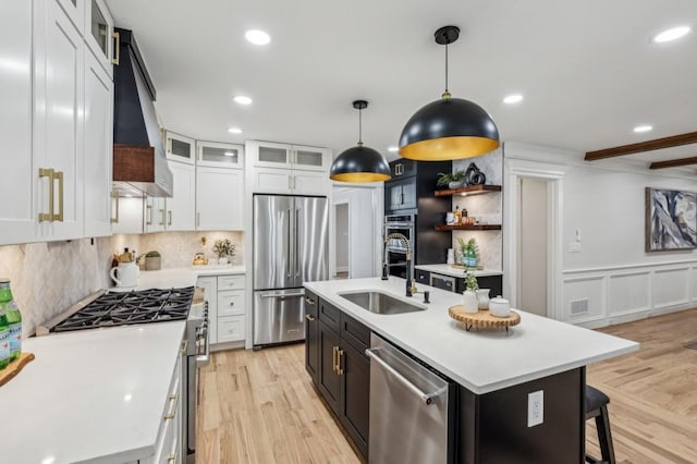 6124 Kings Mountain Ct, Stone Mountain, GA 30087 - kitchen featuring light countertops, premium range hood, a sink, high end appliances, and light wood-style flooring