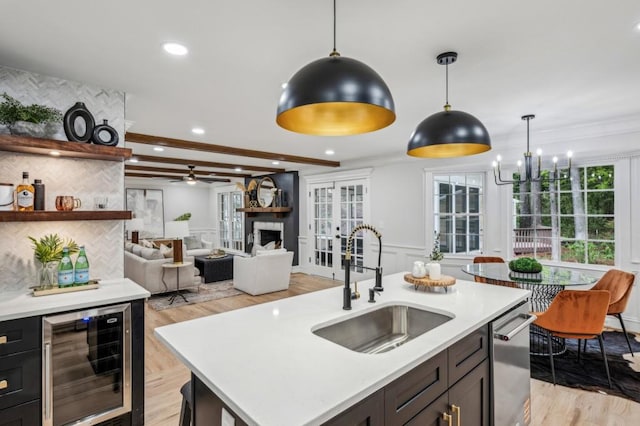 6124 Kings Mountain Ct, Stone Mountain, GA 30087 - kitchen featuring light countertops, a sink, beverage cooler, hanging light fixtures, and stainless steel dishwasher