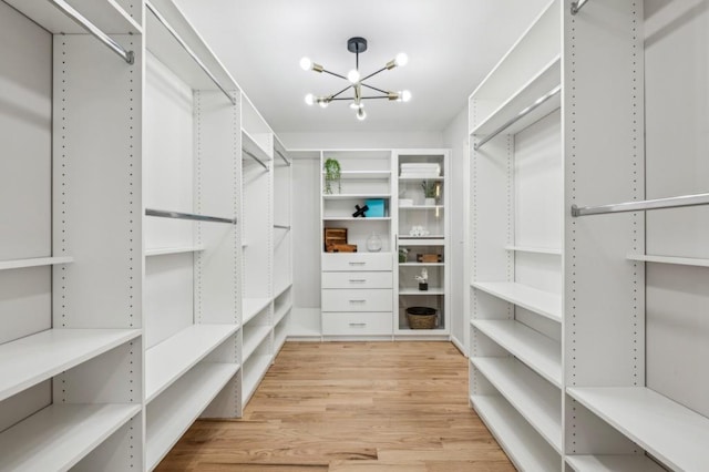 6124 Kings Mountain Ct, Stone Mountain, GA 30087 - walk in closet featuring wood finished floors and a notable chandelier