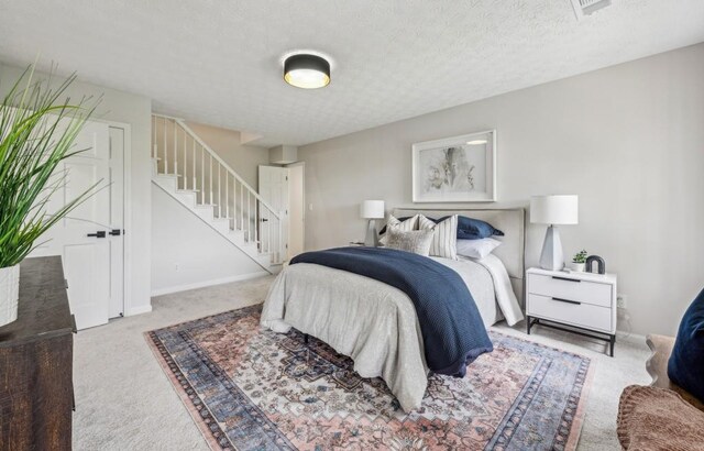 6124 Kings Mountain Ct, Stone Mountain, GA 30087 - carpeted bedroom with baseboards and a textured ceiling