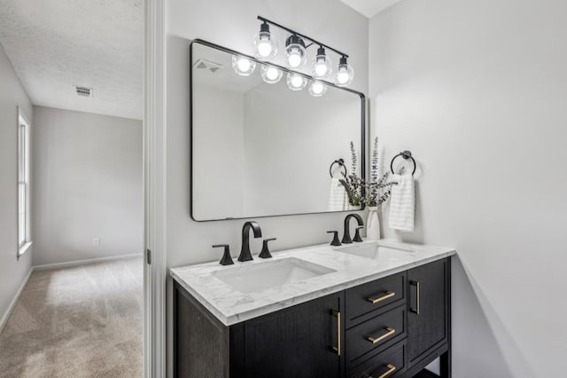 6124 Kings Mountain Ct, Stone Mountain, GA 30087 - bathroom with baseboards, visible vents, a sink, and a textured ceiling