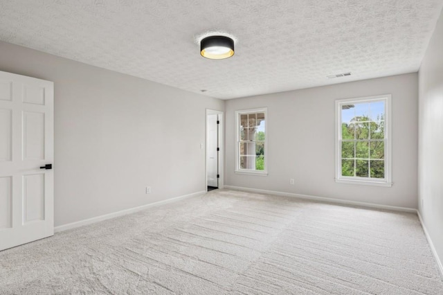 6124 Kings Mountain Ct, Stone Mountain, GA 30087 - spare room featuring carpet flooring, a textured ceiling, baseboards, and visible vents