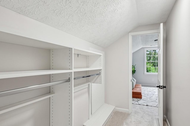 6124 Kings Mountain Ct, Stone Mountain, GA 30087 - walk in closet featuring vaulted ceiling and carpet floors