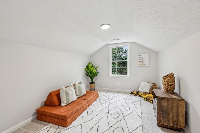6124 Kings Mountain Ct, Stone Mountain, GA 30087 - living area with carpet flooring, a textured ceiling, visible vents, and vaulted ceiling