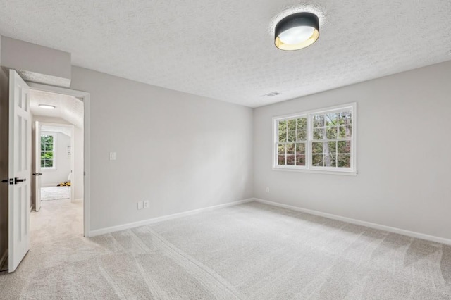 6124 Kings Mountain Ct, Stone Mountain, GA 30087 - empty room featuring baseboards, a textured ceiling, and light colored carpet