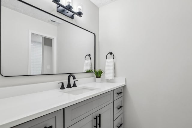 6124 Kings Mountain Ct, Stone Mountain, GA 30087 - bathroom with vanity, a textured ceiling, and visible vents