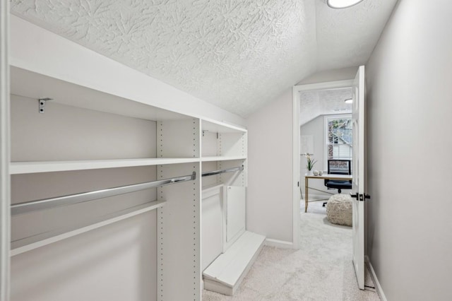 6124 Kings Mountain Ct, Stone Mountain, GA 30087 - spacious closet with light colored carpet and vaulted ceiling