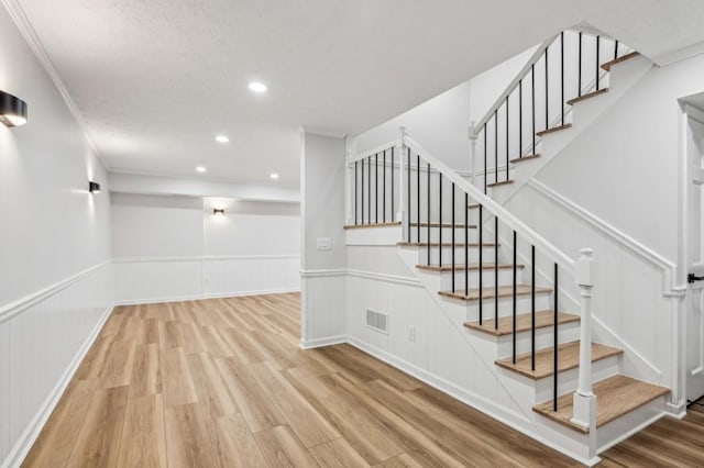 6124 Kings Mountain Ct, Stone Mountain, GA 30087 - staircase with visible vents, wood finished floors, recessed lighting, and wainscoting