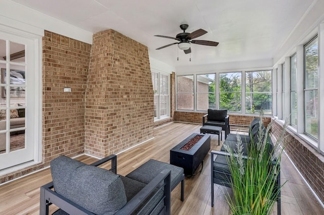 6124 Kings Mountain Ct, Stone Mountain, GA 30087 - sunroom with a ceiling fan, a fire pit, brick wall, and a wealth of natural light
