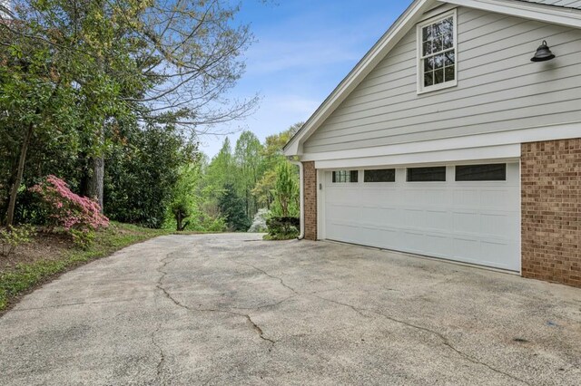 6124 Kings Mountain Ct, Stone Mountain, GA 30087 - garage featuring concrete driveway