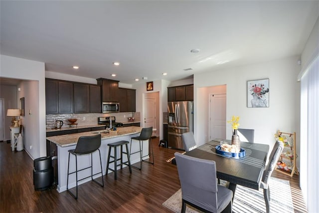 dining area with dark wood-type flooring and sink