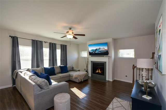 living room with ceiling fan, a healthy amount of sunlight, and dark hardwood / wood-style floors