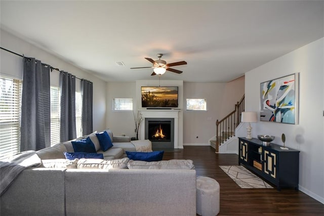 living room featuring dark hardwood / wood-style flooring and ceiling fan